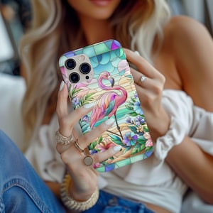 May include: A phone case with a stained-glass effect, depicting a flamingo. The design incorporates pastel colours, including pink, blue, and green. The flamingo is surrounded by floral and tropical motifs, creating a vibrant and artistic appearance.