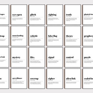 May include: A collection of framed art prints with black frames and white backgrounds. Each print features a single word in bold black text, such as "hidden tapes" or "eyes open", along with a brief definition below.