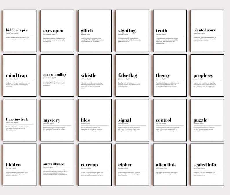 May include: A collection of framed art prints with black frames and white backgrounds. Each print features a single word in bold black text, such as "hidden tapes" or "eyes open", along with a brief definition below.