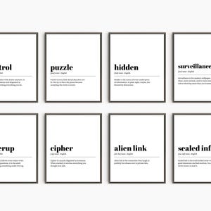 May include: Eight framed art prints with black frames and white backgrounds. Each print features a word in bold black text, such as "control" or "puzzle", along with a definition. The prints are arranged in two rows of four.