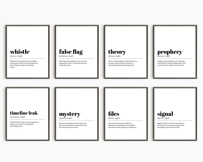 May include: Eight framed prints with black frames and white backgrounds. Each print features a word in bold black text, such as "whistle" or "false flag", with a definition below. The prints are arranged in two rows of four.