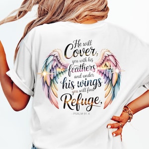 May include: White t-shirt featuring a colorful angel wing design with the text "He will Cover, you with his feathers and under his wings you will find Refuge, - PSALM 91:4". The wings are in shades of pink, blue, yellow, and green.