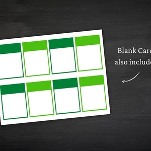 May include: A sheet of white blank cards with a green and light green border. The text "Blank Cards also included!" is written in black. The cards are on a black surface.