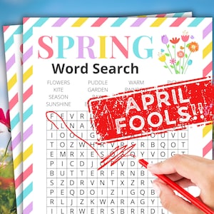 以下が含まれることがあります： カラフルな文字で「SPRING」という単語が上部に書かれた春をテーマにしたワードサーチパズル。パズルは赤いペンでマークされており、「APRIL FOOLS!!」と書かれた赤いスタンプがページに押されています。