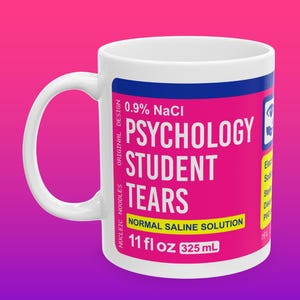 May include: White ceramic mug with a pink and blue label that reads "0.9% NaCl Psychology Student Tears Normal Saline Solution 11 fl oz 325 mL".