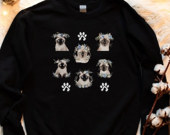 May include: Black sweatshirt with a white paw print and six images of Siamese cats wearing flower crowns.