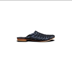 May include: Black leather woven slip-on mule with a brown leather sole.