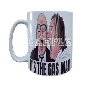 May include: White ceramic mug featuring a colourful illustration of two men with the text "It's the Gas Man" printed on the front.