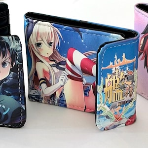 May include: Three open wallets with colorful anime character designs. The wallets are black on the inside and feature different anime characters on the outside. One wallet has Japanese text and a character with black hair. Another has a character with blonde hair. The third has a character with red and black hair.