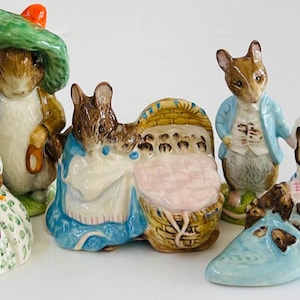 May include: A set of five Beatrix Potter figurines featuring Peter Rabbit, Mrs. Tiggy-Winkle, Jemima Puddle-Duck, Benjamin Bunny, and a baby in a basket. The figurines are made of porcelain and are painted in bright colors.