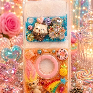 May include: A clear phone case with a playful design. The top section has a cat in an ice cream cone and a clear teddy bear. The bottom section features a troll doll, a rainbow, and a donut. The case is filled with glitter and small decorative elements.