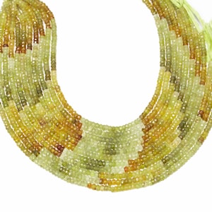 May include: Multiple strands of faceted gemstone beads in yellow, green, and brown hues. The beads are strung together, creating a layered effect. The gemstones have a subtle sparkle and are arranged in a gradient pattern.