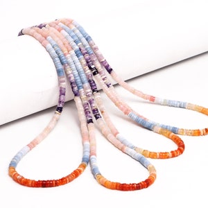 May include: A set of four strands of colorful gemstone beads. The beads are small and round, and they are strung on a thin cord. The colors of the beads are pink, blue, orange, and purple.
