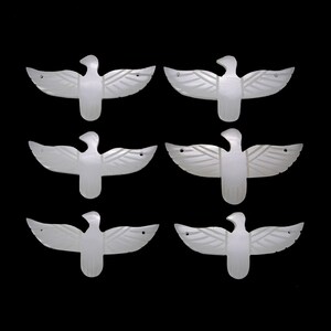 May include: Six white, carved, mother-of-pearl bird shapes with outstretched wings.