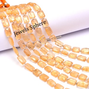 May include: A strand of orange citrine gemstone beads, each bead is rectangular and faceted. The beads are strung on a silver wire and are approximately 10mm in length. The strand is approximately 18 inches long. The image includes the text "Jewels Sphere".