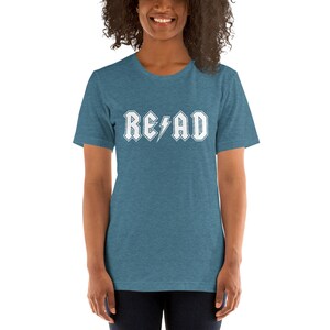 May include: A teal blue t-shirt with a white graphic that says "READ" in a rock and roll font with a lightning bolt.