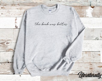 May include: Gray sweatshirt with the text "the book was better" printed in black.