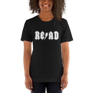 May include: Black short-sleeved t-shirt with a white graphic of the word "READ" in a rock and roll font with a lightning bolt.
