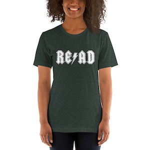 May include: A dark green t-shirt with a white graphic that says "READ" in a rock and roll font with a lightning bolt.