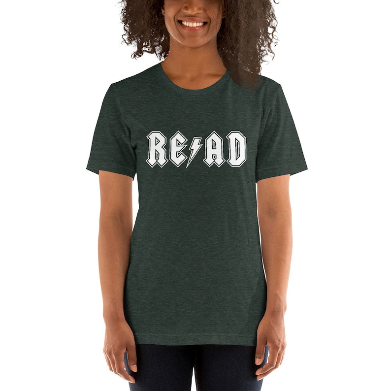 May include: A dark green t-shirt with a white graphic that says "READ" in a rock and roll font with a lightning bolt.
