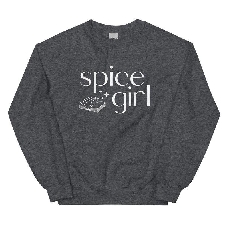 May include: A dark gray sweatshirt with the words "spice girl" in white script. A small open book graphic is below the words. The sweatshirt is a casual style.
