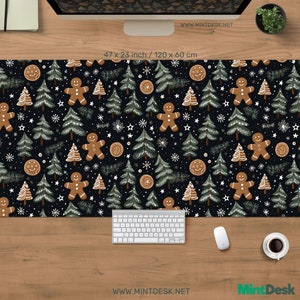 May include: A black desk mat with a festive Christmas pattern. The design features gingerbread men, pine trees, and snowflakes. The mat measures 120 x 60 cm. The text "WWW.MINTDESK.NET" and "Mint Desk" are visible.