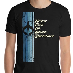 May include: Black t-shirt with a blue and white vertical stripe design on the left side. The shirt features the text "Never Give Up, Never Surrender" in a stylized font. A dark emblem is above the text.