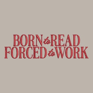 May include: Red embroidered text on a tan background reads "BORN to READ FORCED to WORK." The text is in a serif font, with the word "to" in a script font. The image is a close-up of the text.
