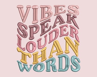 May include: A colorful graphic design with the text "Vibes Speak Louder Than Words" in a rainbow of colors. The text is in a stylized font and is arranged in a circular pattern.