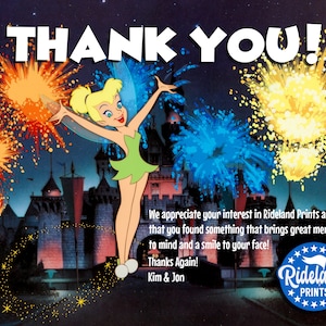 May include: A thank you card featuring Tinkerbell from Disney's Peter Pan, with a nighttime fireworks display over a castle in the background. The card includes the text "THANK YOU!" and "Rideland Prints".