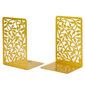 Könnte beinhalten: Ein Paar goldene Buchstützen aus Metall mit einem Blattdesign. Die Buchstützen sind aus Metall und haben eine goldene Oberfläche.