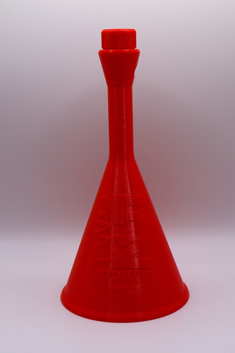 May include: A bright red plastic funnel with a narrow spout and a wide base. The funnel has the words "Additive" and "5 oz" printed on the side.