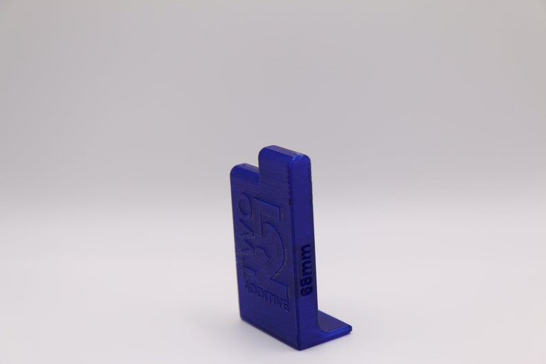 May include: A blue plastic 3D printed object with the text "Additive" and "68mm" on it.