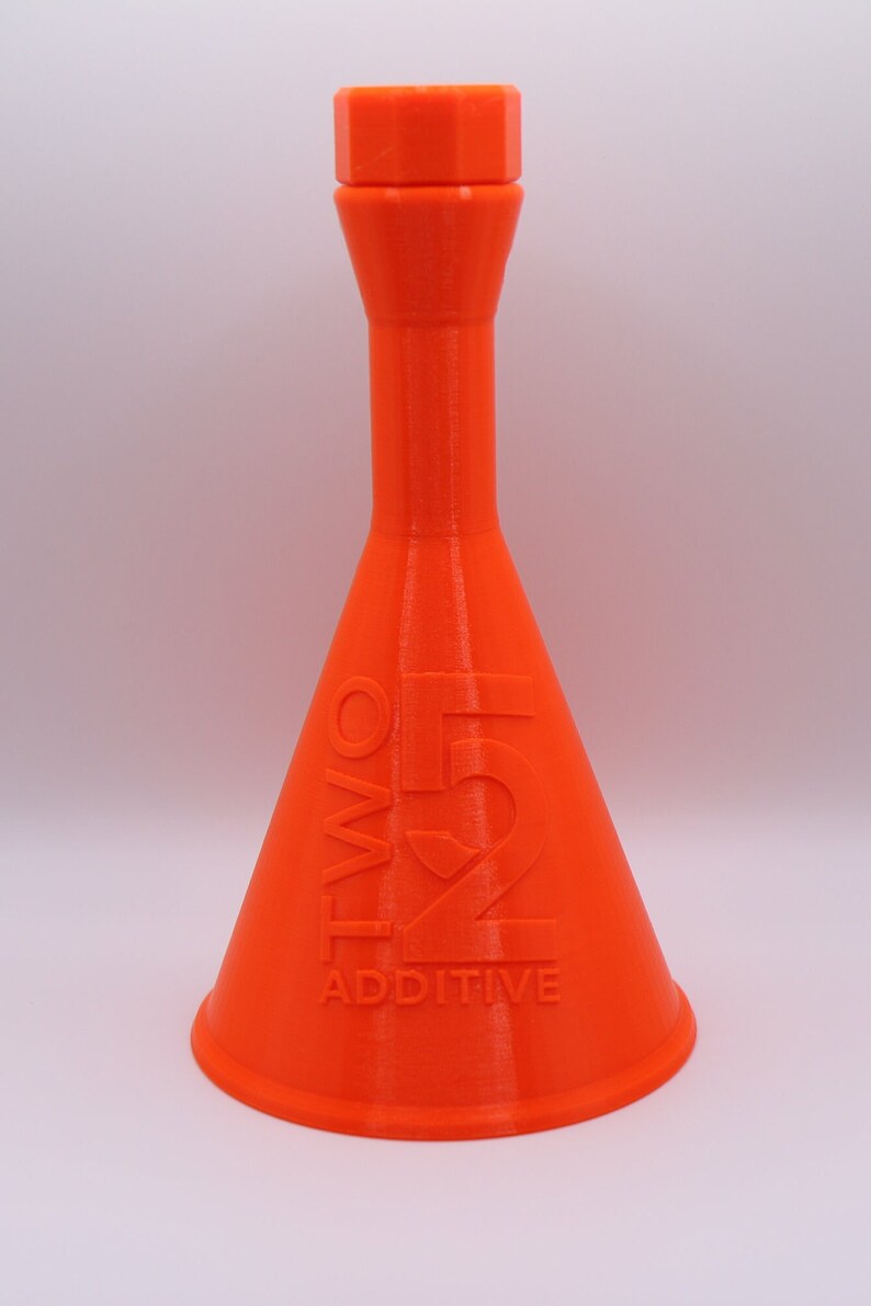 May include: An orange plastic bottle with a wide base and a narrow neck. The bottle has the text "TWO51 ADDITIVE" printed on the side.