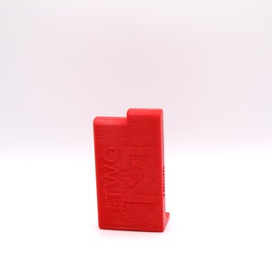 May include: A red plastic box with the text "TWO FIVE ADDITIVE" printed on the front.
