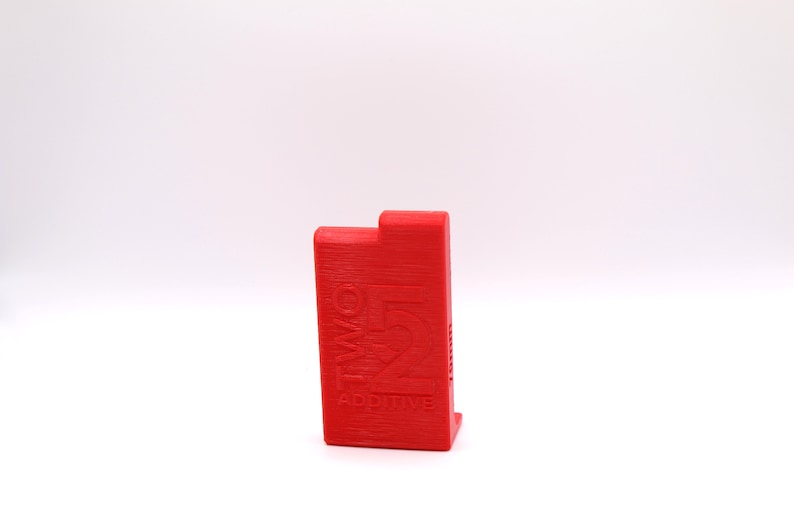 May include: A red plastic box with the text "TWO FIVE ADDITIVE" printed on the front.