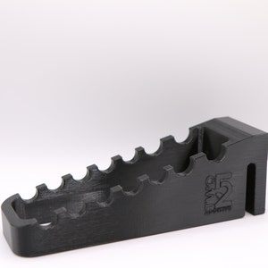 May include: Black plastic 3D printed tool holder with multiple slots and the text "TWO 52 ADDITIVE" on the side.