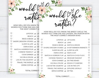May include: Two white bridal shower game cards with floral accents. The cards feature the text "would she rather?" and a list of choices for guests to select. The game is designed to test how well guests know the bride.