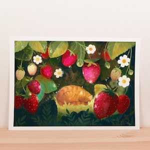 May include: A charming illustration depicting a sleeping ginger cat amongst ripe strawberries and green foliage. The artwork features red strawberries, white flowers, and lush green leaves, creating a peaceful, nature-inspired scene.