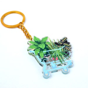 ショッピングカートのキーホルダーに入った観葉植物 - 透明アクリルチャーム - 「植物の友達」