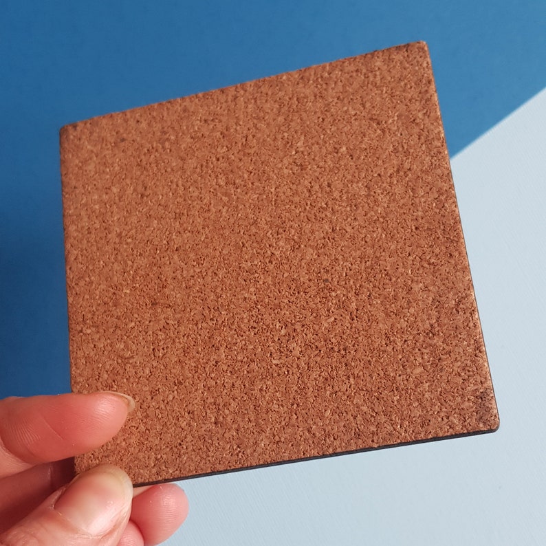 May include: A brown corkboard with a slightly textured surface.