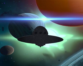 May include: A black silhouette of a flying saucer against a backdrop of a green and blue nebula with a bright light shining through the center. There are several planets and stars in the background.