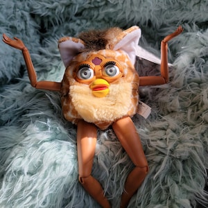 furby with arms and legs