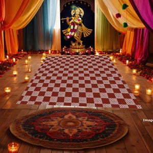 May include: An ornate, colorful interior scene with a statue of a deity, a checkered rug, and a patterned rug. The space is decorated with candles, flowers, and draped fabrics in various colors, creating a warm and inviting atmosphere.