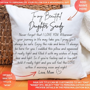 May include: White pillow with a message that reads "To my Beautiful Daughter Sandy" and "Never forget that I LOVE YOU. Wherever your journey in life may take you, I pray you'll always be safe. Enjoy the ride and know I'll always be here for you. I cuddled this pillow and squeezed it really tight and filled it with my wishes of hope, love and light. So if you're feeling sad or low just hold it really tight and you will feel the LOVE within it morning, noon and night. Love, Mom".