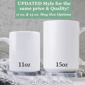 May include: Two white ceramic mugs, one 11 ounce and one 15 ounce, with black text indicating their size. The mugs are on a gray and white knitted surface.