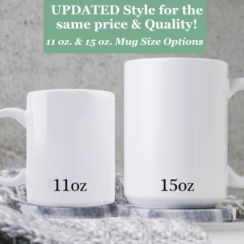 May include: Two white ceramic mugs, one 11 ounce and one 15 ounce, with black text indicating their size. The mugs are on a gray and white knitted surface.