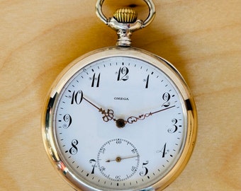 9D510 Antique Omega silver, embedded gold winged wheel pocket watch
