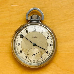 2T820 Omega fickur från museisamlingen, nikromboett, kaliber 38.5 L1