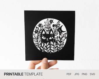 May include: Black and white printable template featuring a cat peeking out from behind a circle of leaves and stars. The template is perfect for paper cutting or crafting.